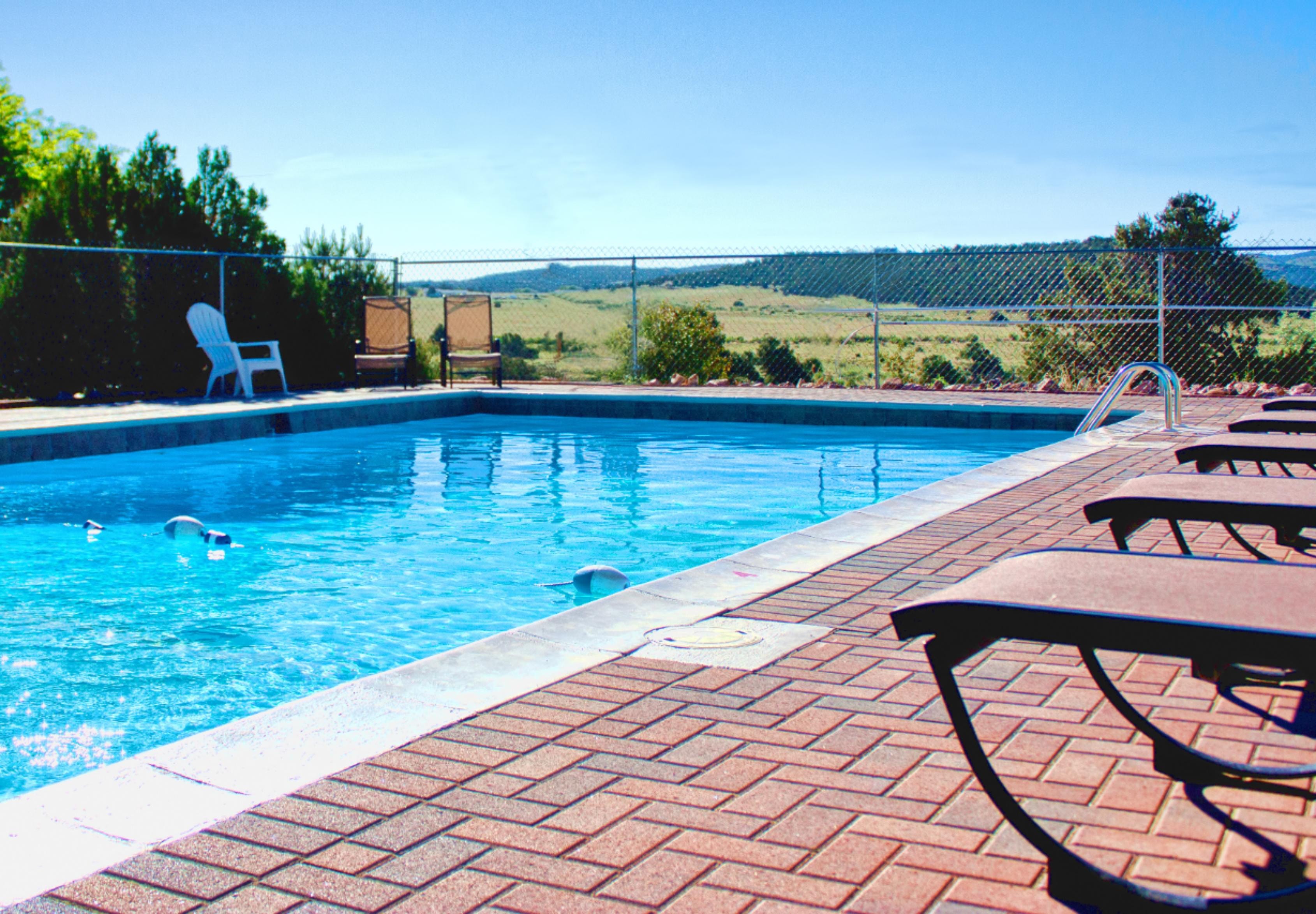 Outdoor pool with mountain views at Royal View RV Park